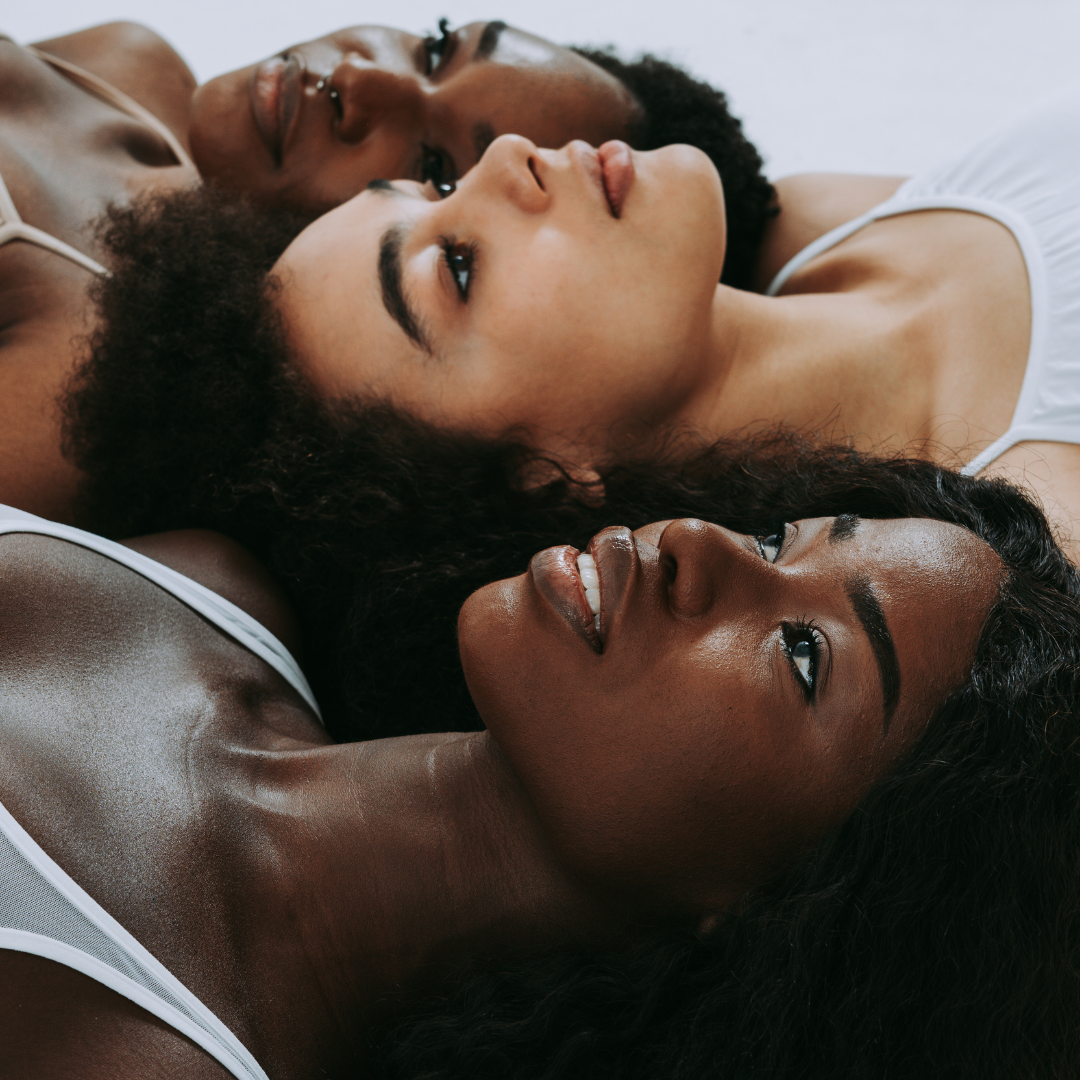 three black women laying down